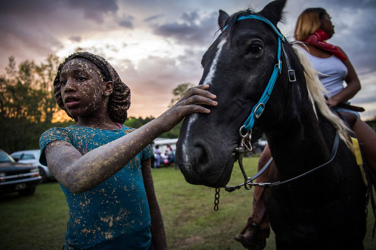 © Rory Doyle - Bree Gary pets her friend’s horse during a muddy trail ride in Charleston, Mississippi on April 27, 2019.