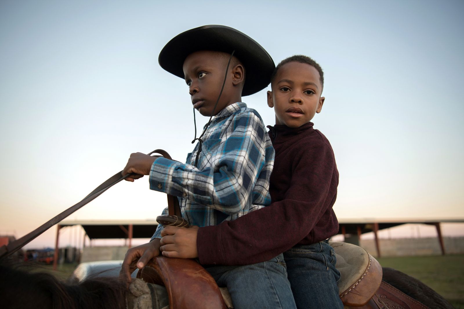 © Rory Doyle - D’Kamiyon Johnson, left, and Carlos Smith share a horse outside a rodeo in Greenville, Mississippi Oct. 27, 2018.