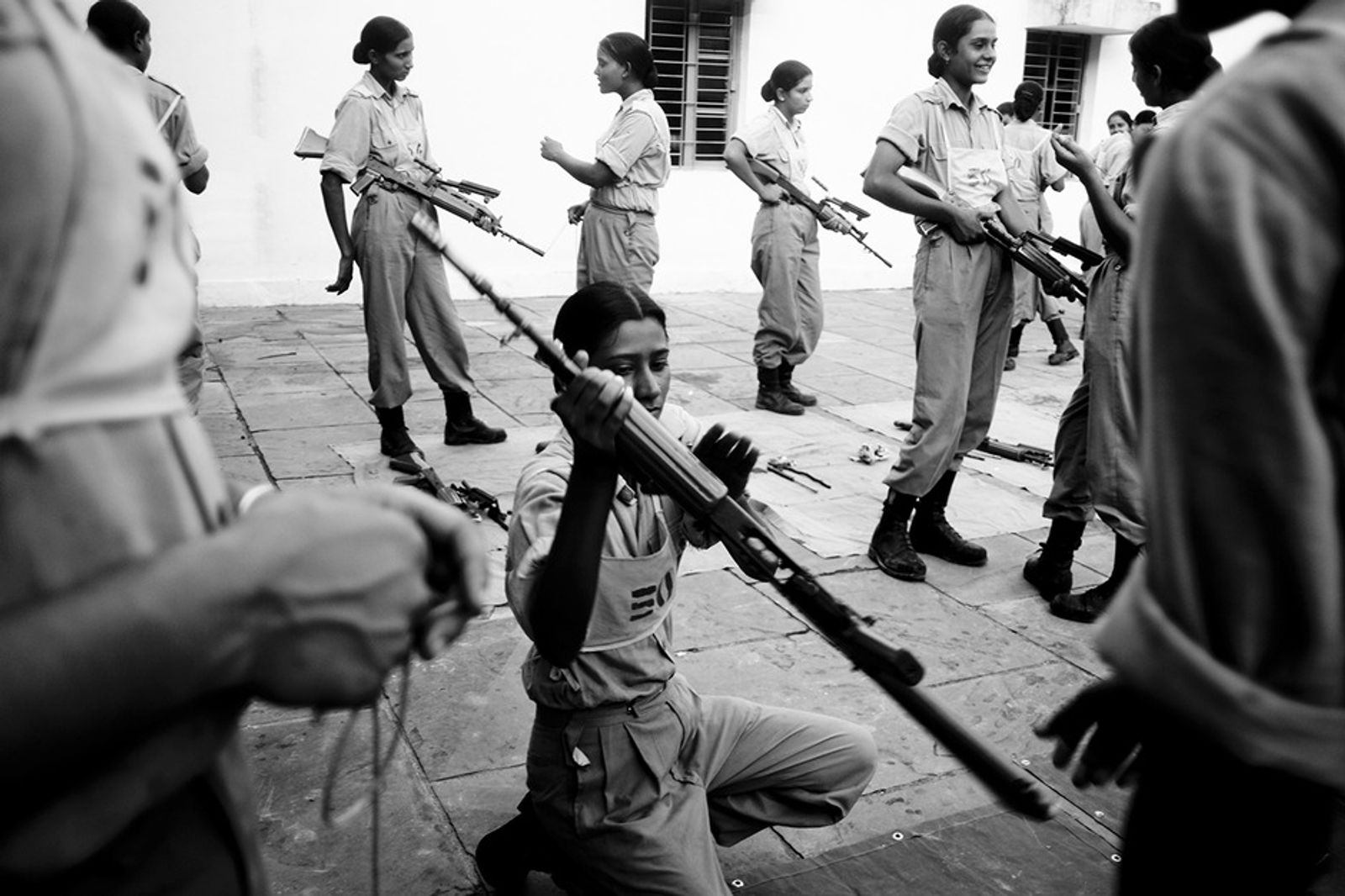 © Poulomi Basu - Women from the Indian Border Security Armed Force during a weapon-cleaning session in their training, Kharkan, August 2009.
