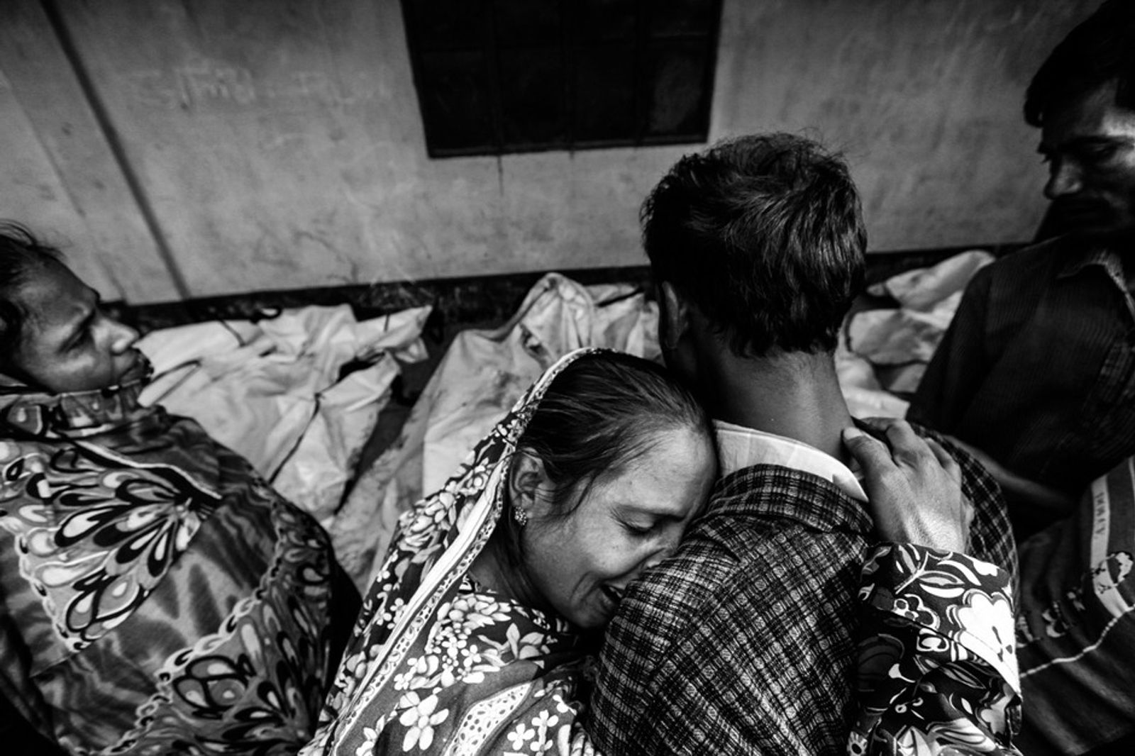 © Andrew Biraj - Relatives mourn the death of a garment worker after a fire occurred in a garment factory in Savar November.