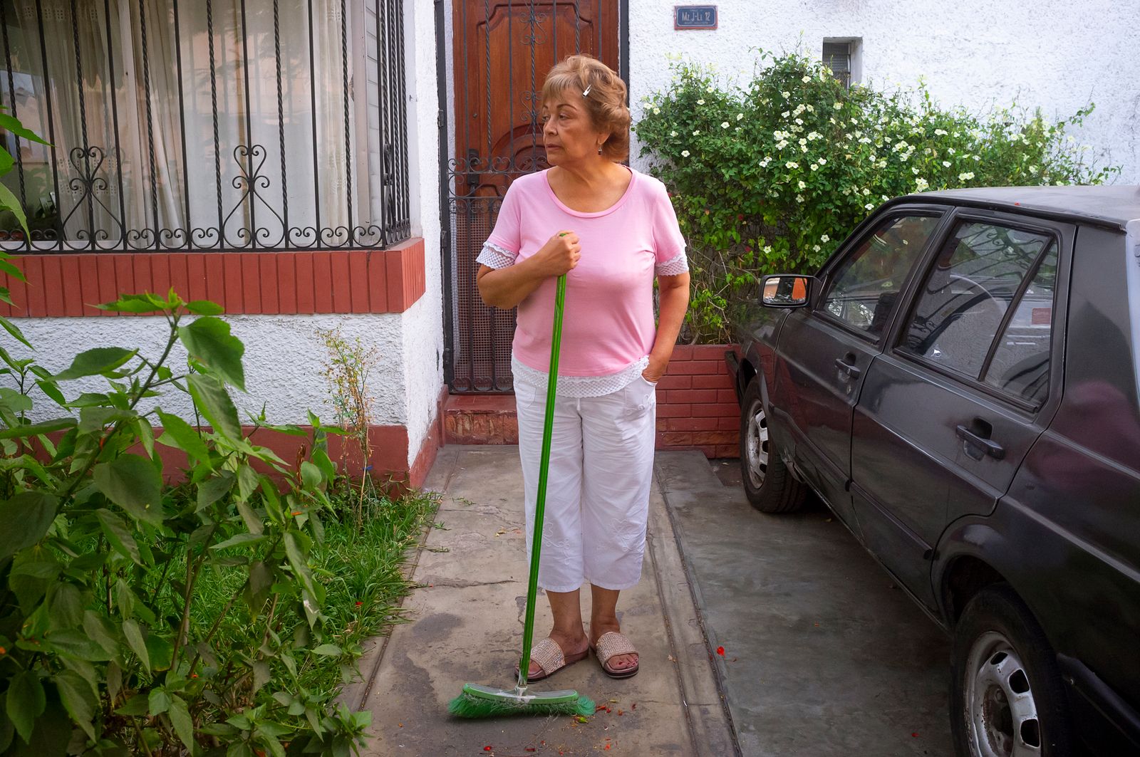 © Rochi  Leon - My mom watches the street while sweeping.