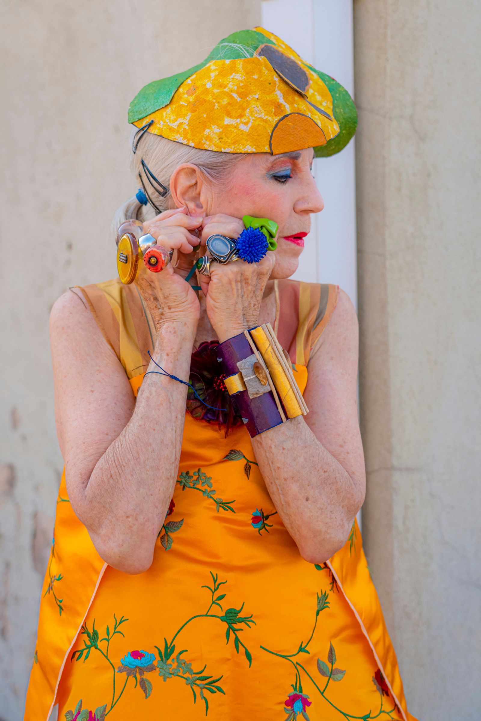 © Natalia L Rudychev - Vulnerable moment. Debra Rapoport wearing her toilet paper bracelets and recycled materials hat.