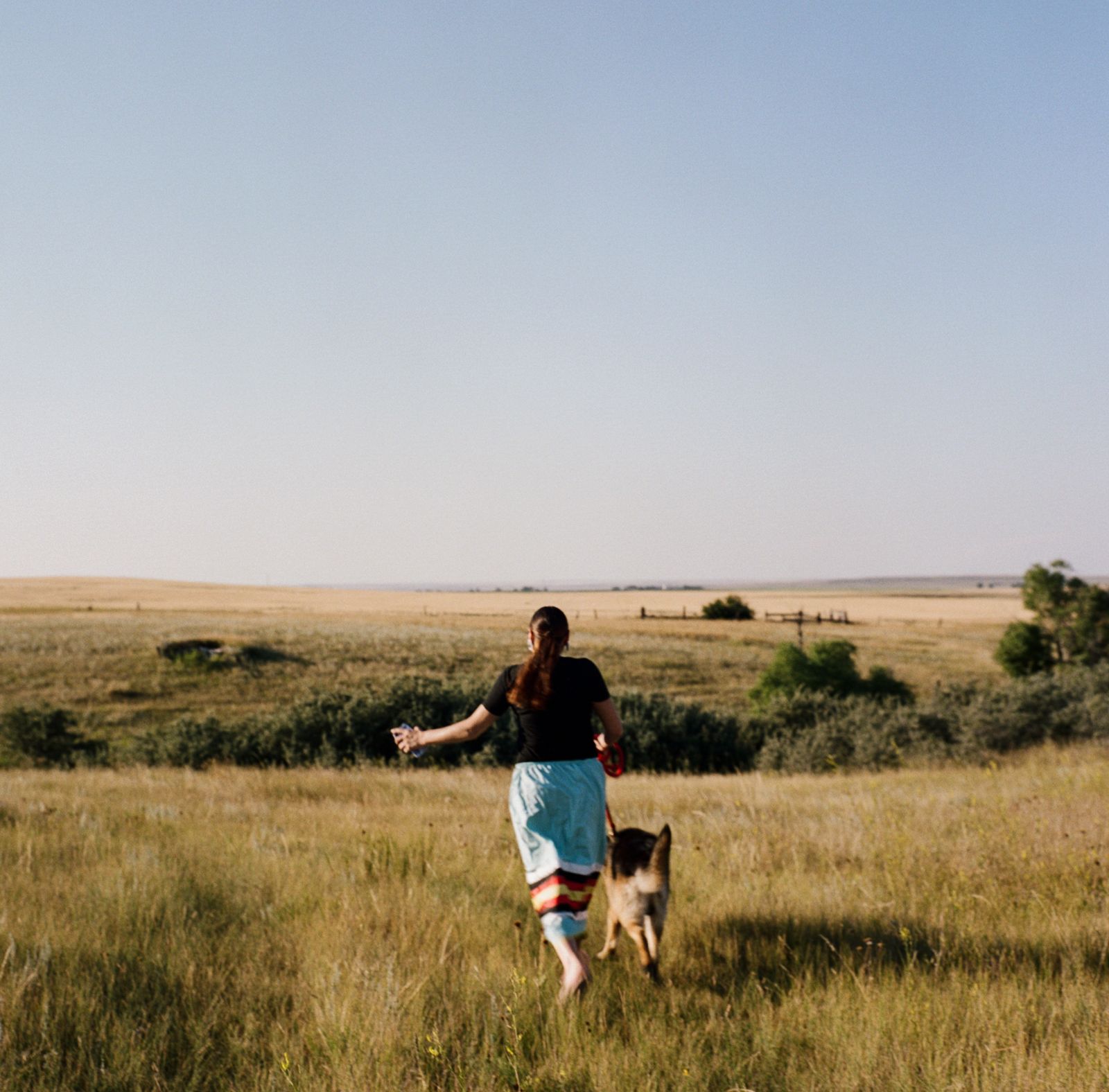 © Sara Hylton - Heather Belgrace, 23, runs with her dog, Vador, near her home in Fort Kipp, on Fort Peck Indian Reservation.