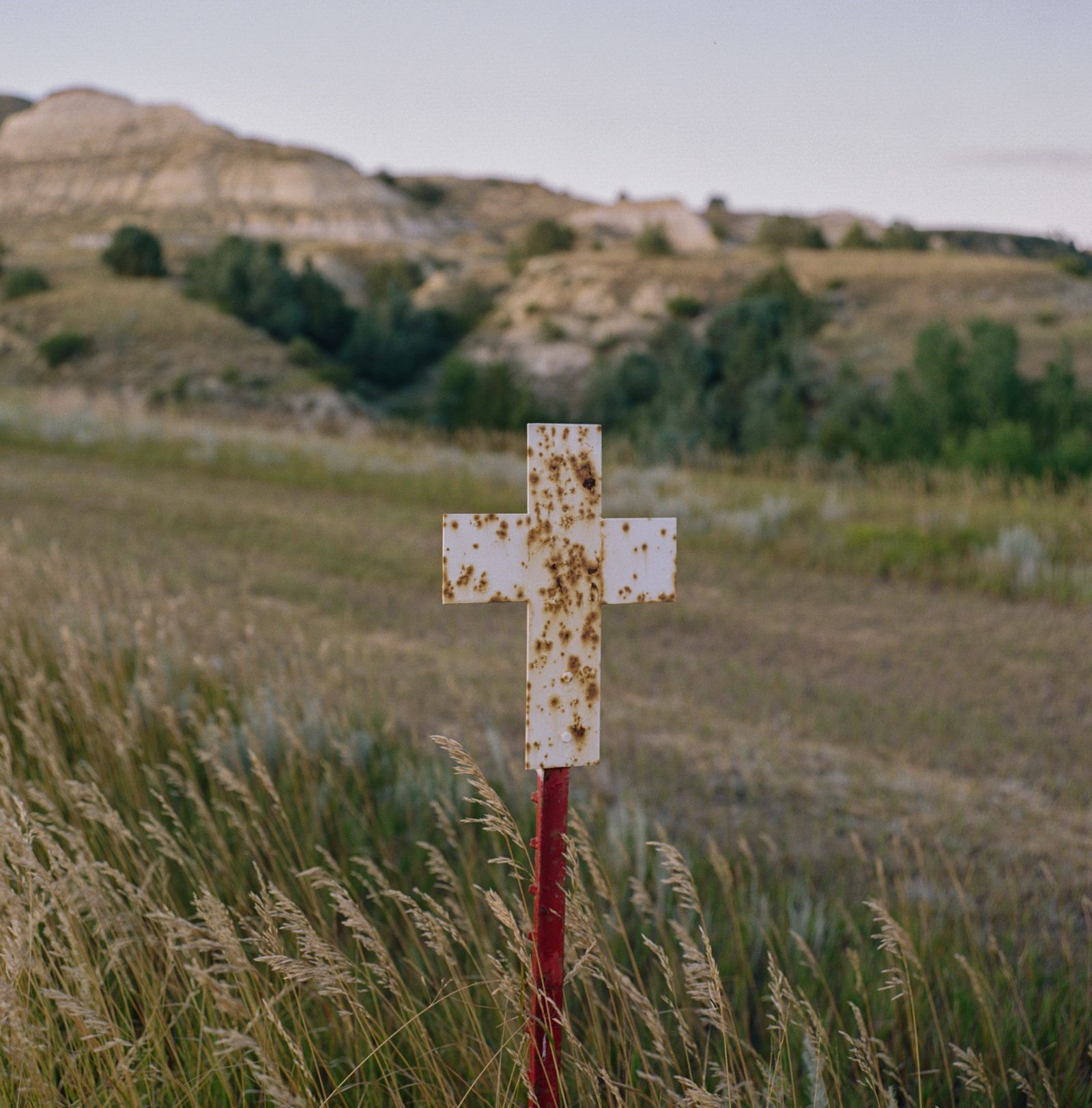 © Sara Hylton - A symbolic cross on the side of the highway near the Montana-North Dakota state line.