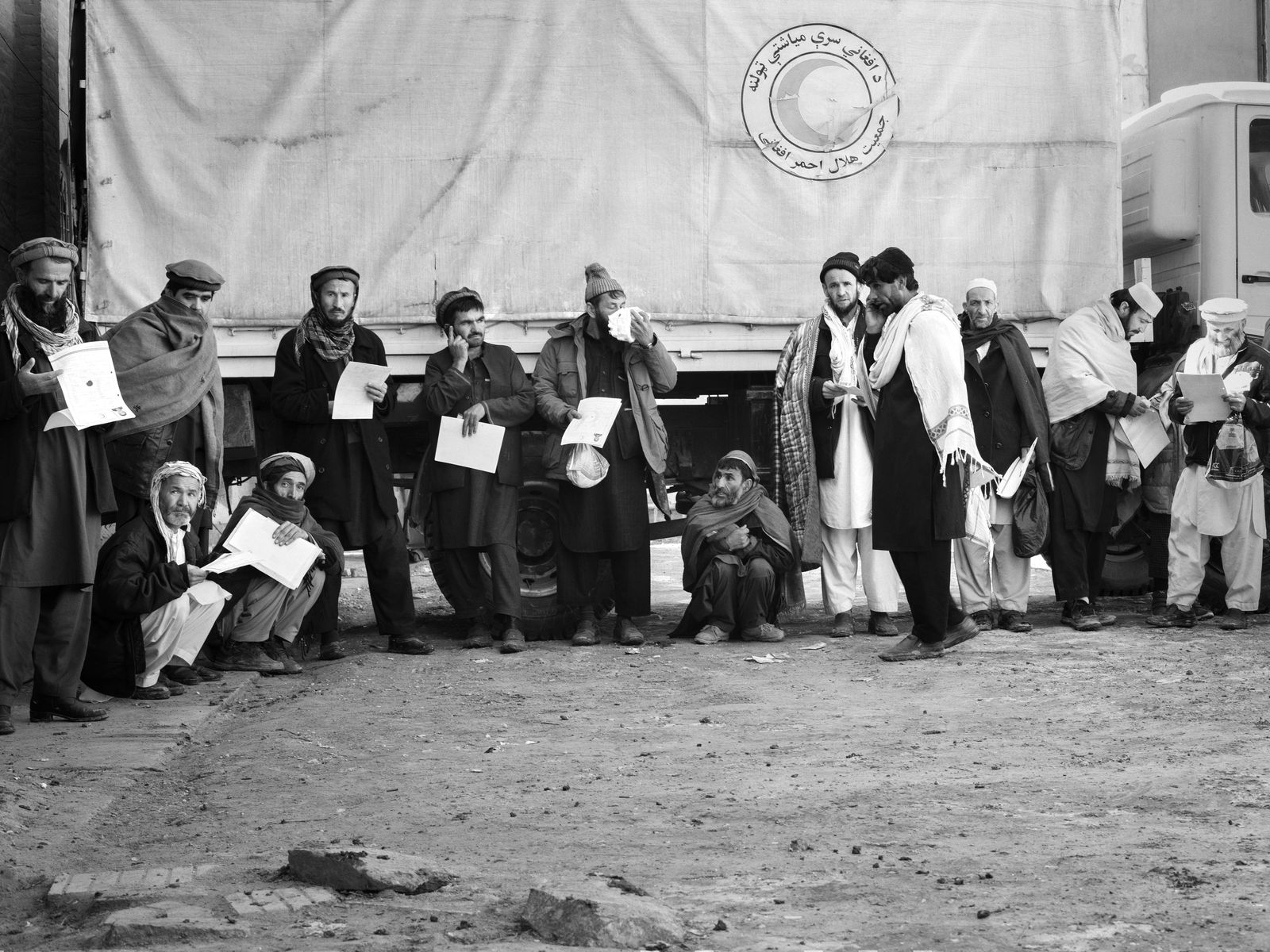 © Toby Binder - Parents wait with their documents in the courtyard of the Red Crescent Kabul.