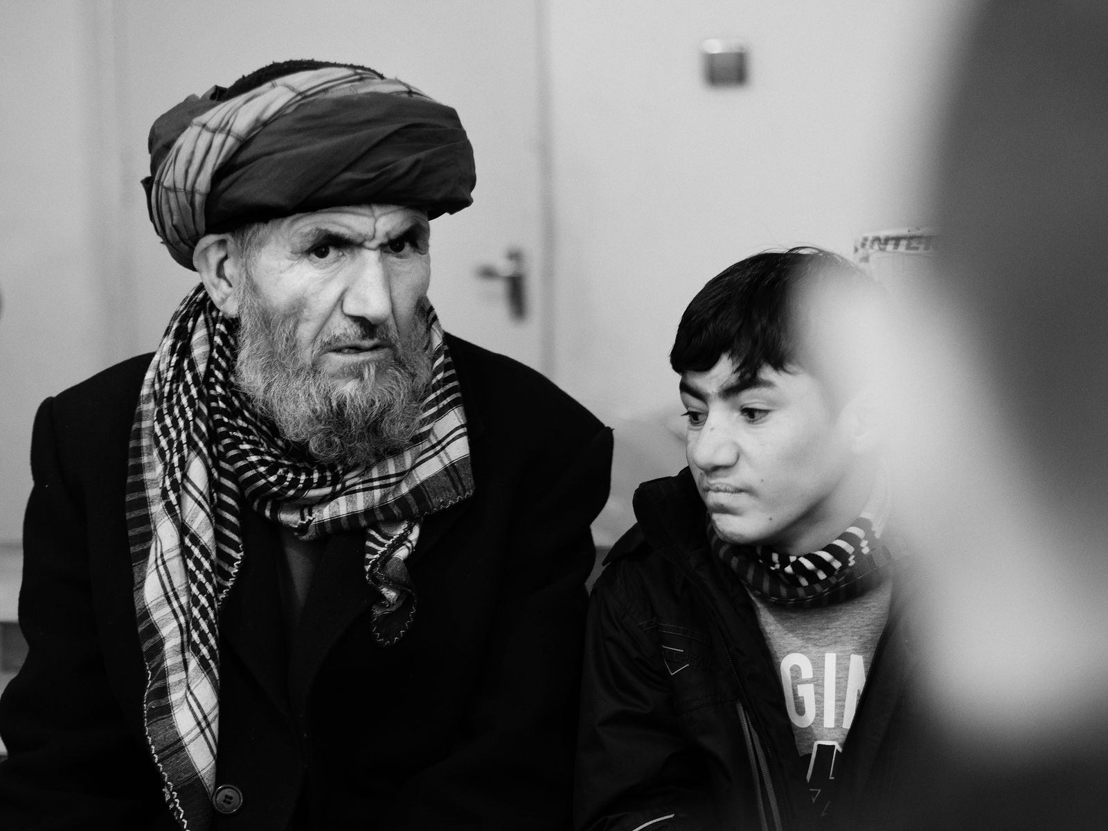 © Toby Binder - Father with his injured son in a patient interview with the local partners of NGO Peace Villlage.