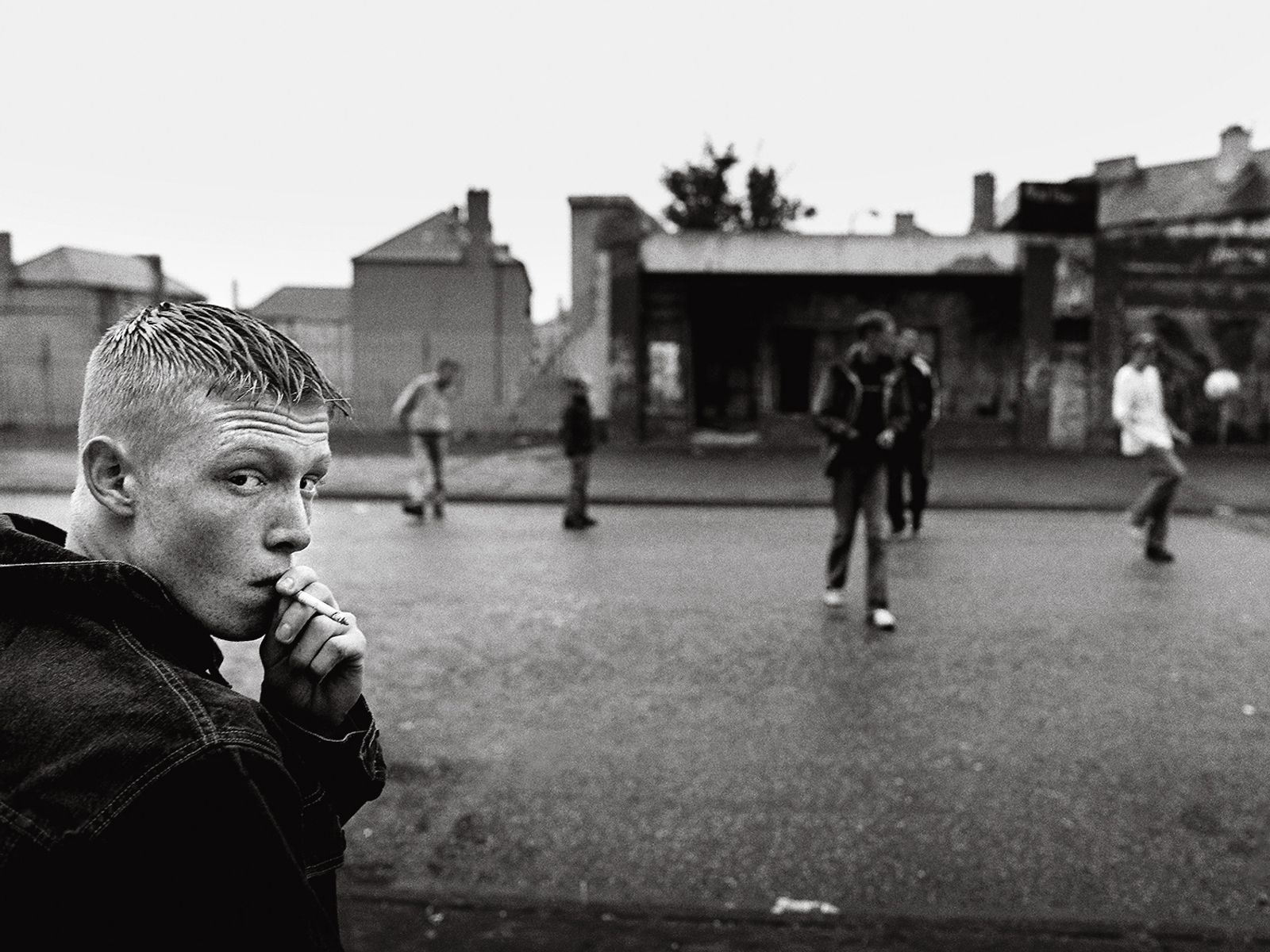© Toby Binder - Edinburgh, Niddrie. Teenagers meeting on the streets for football, cigarettes and alcohol.