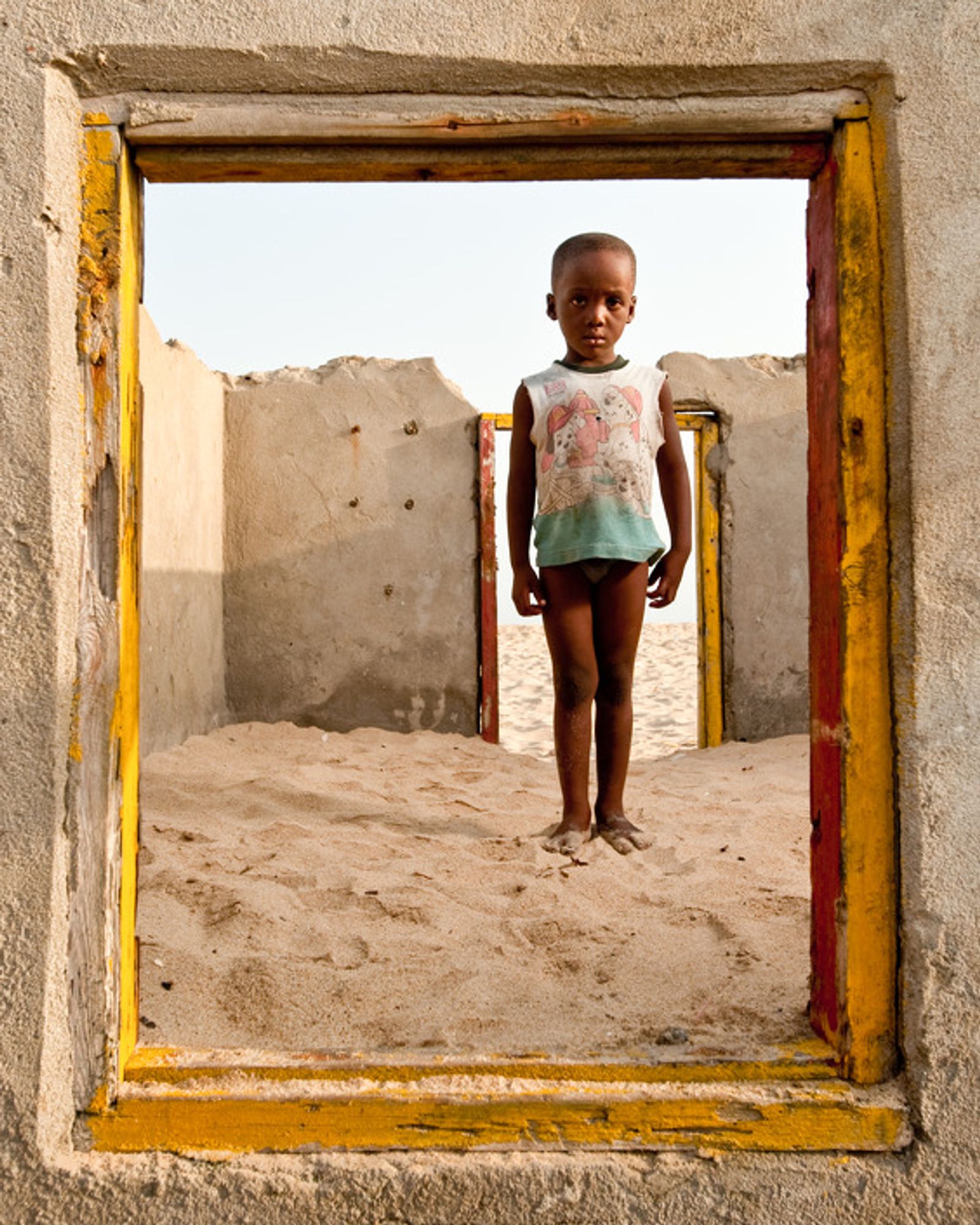 © Nyani Quarmyne - Seven year-old Collins Kusietey in the remains of a house destroyed by the encroaching sea in Totope, Ghana.