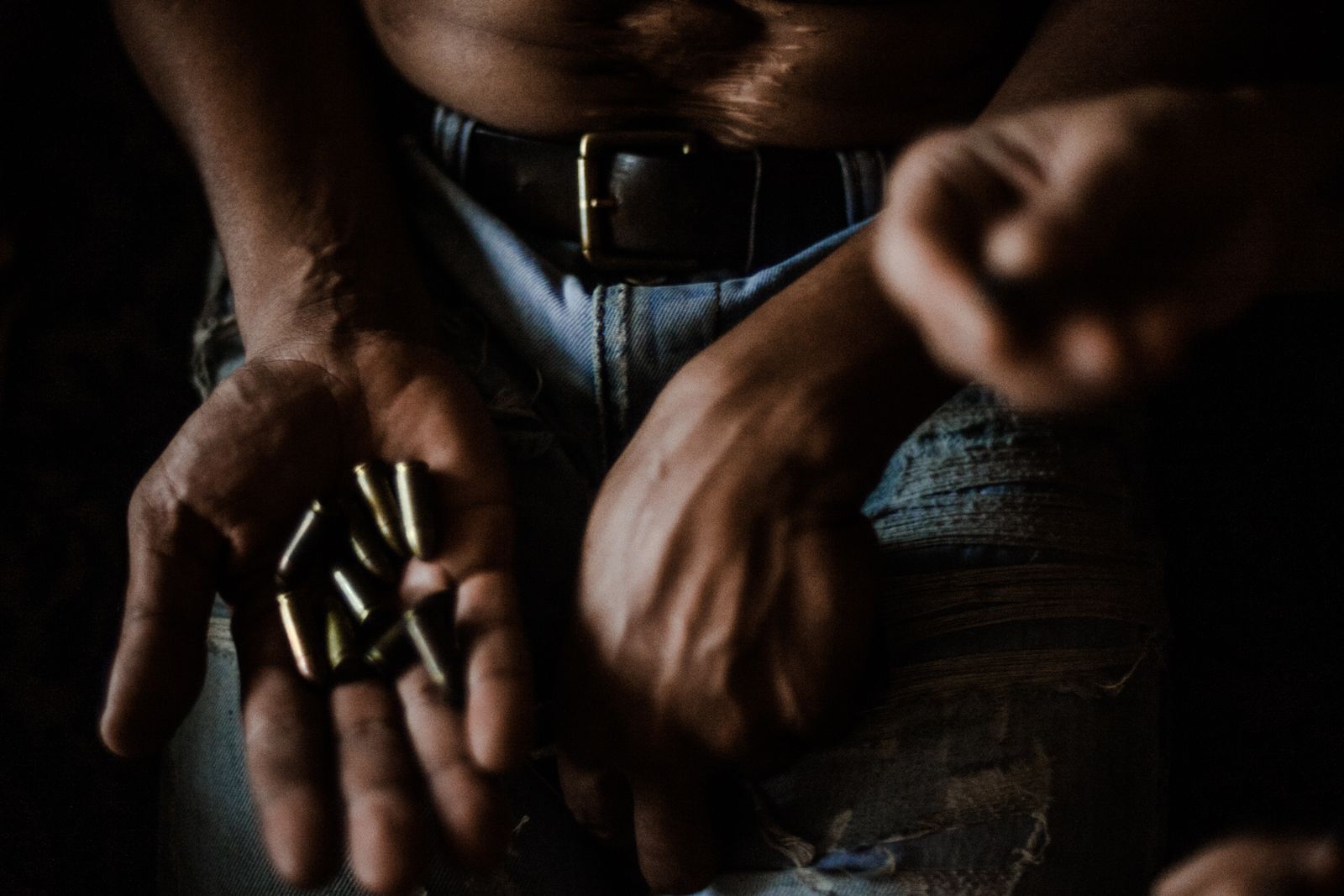 © Celine Croze - El Feo at home showing me his bullets after telling me that he survived 3 bullets in the belly. Caracas, Venezuela, 2015