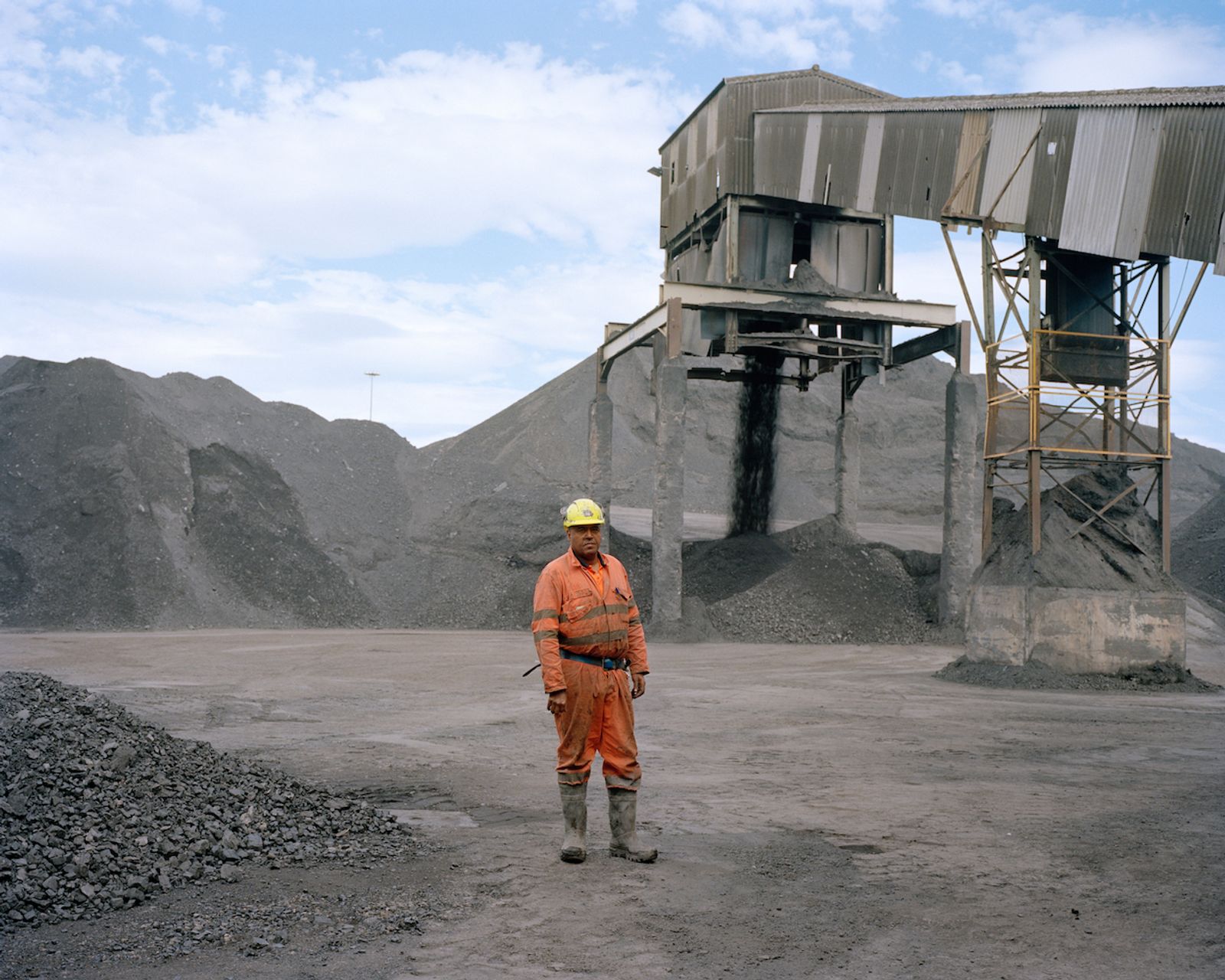 © David Severn - A mineworker at Thoresby Colliery among coal stocks.