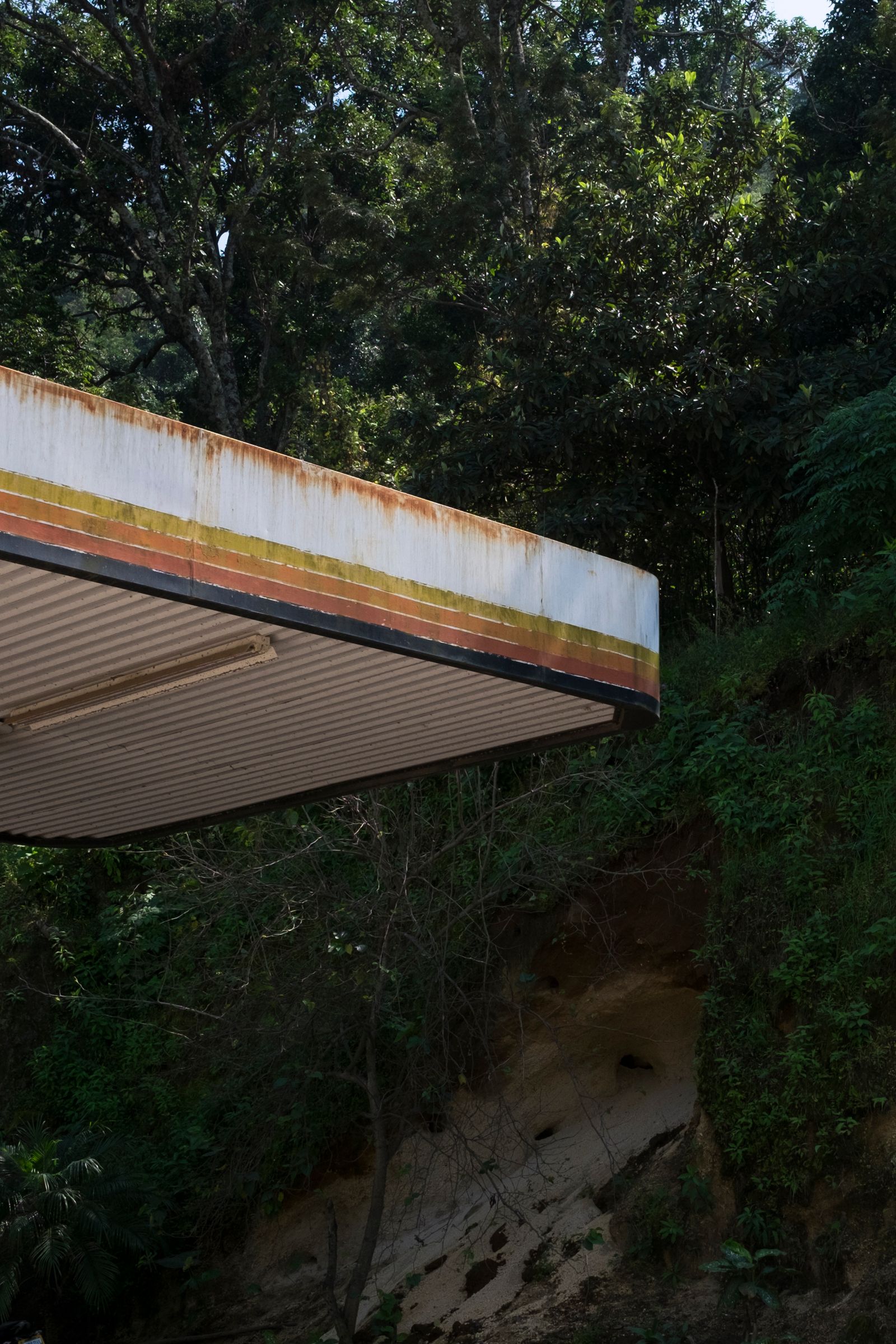 © Cris Veit - A gas station on the road to San Juan la Laguna reminds us of the impact of oil exploration as a form of colonization