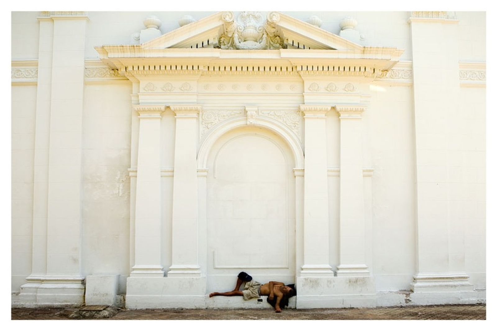 © Jorge Saenz - A homeless man sleeps at Pantheon back wall, Asuncion, Paraguay, Feb. 16, 2009.