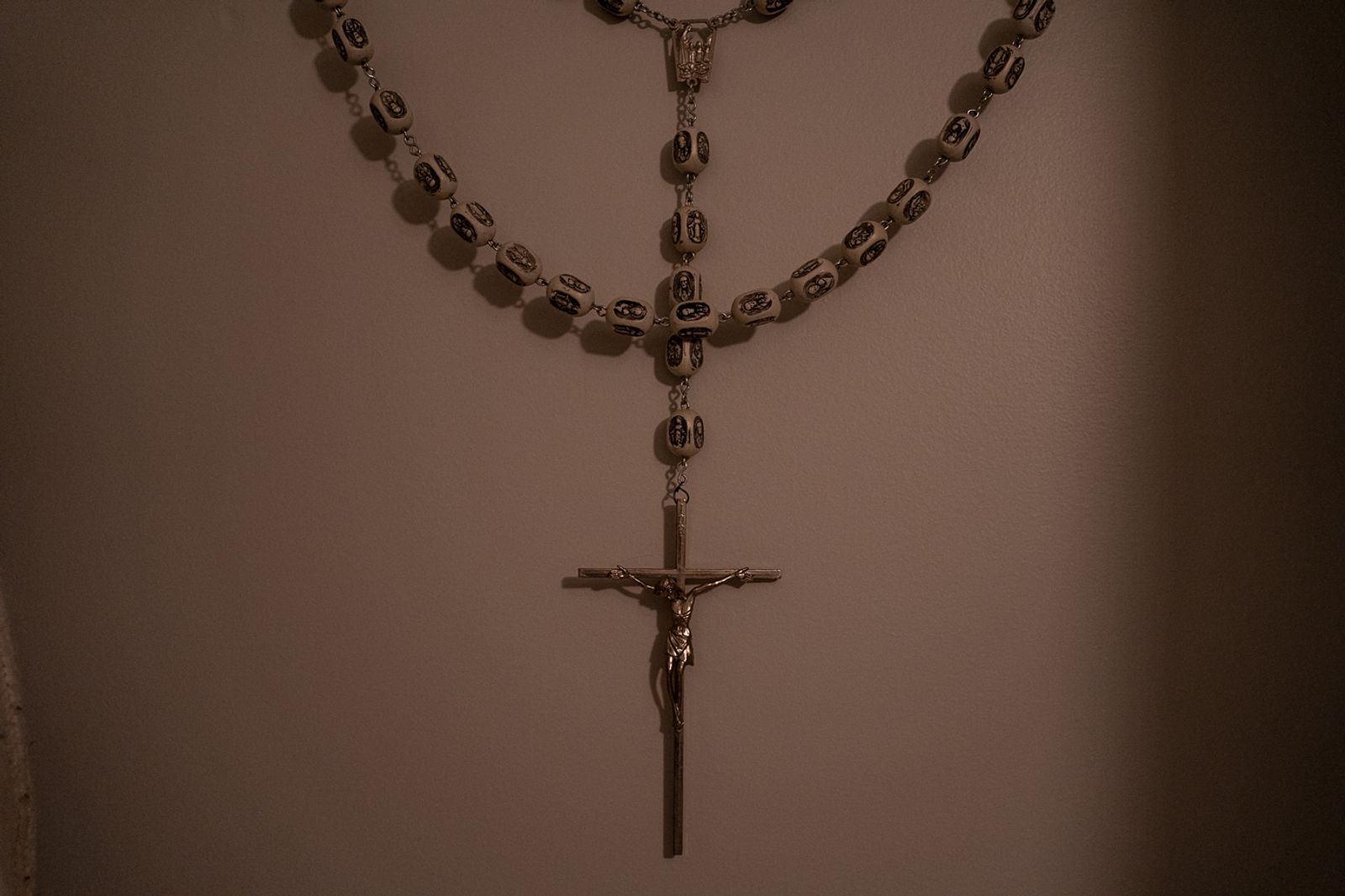 © Bobbi Barbarich - A large rosary hangs on the wall in her bedroom.