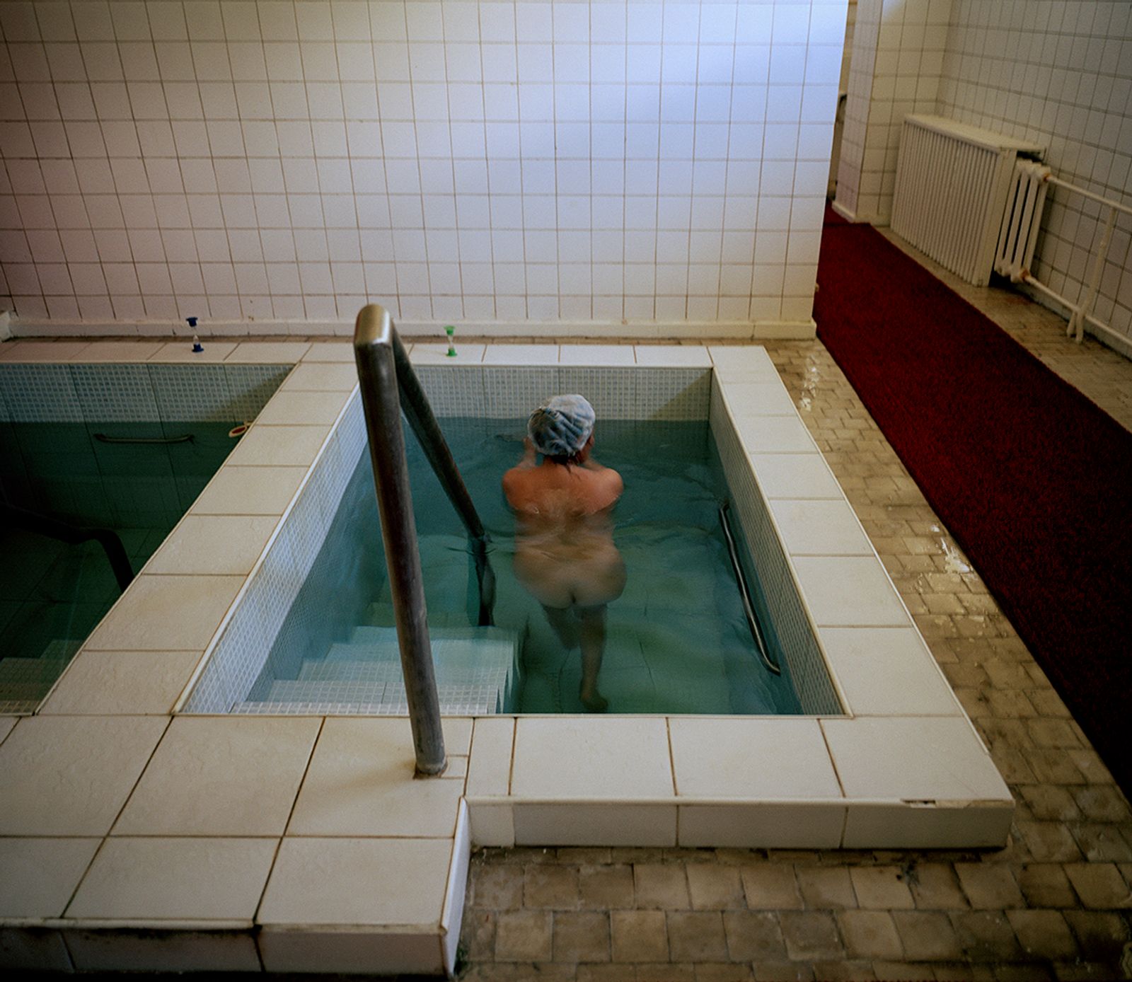 © Michal Solarski - Bath. Woman taking a treatment (mineral water) bath at Aurora sanatorium. Issyk Kul. May 2016, Kyrgyzstan.