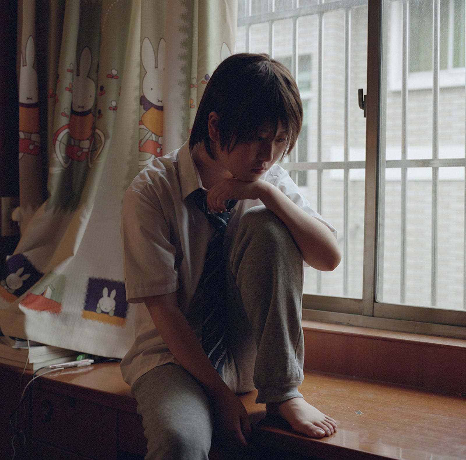 © Bowei Yang - Lu sitting aside by the window in her room, Hangzhou, China, 2013.