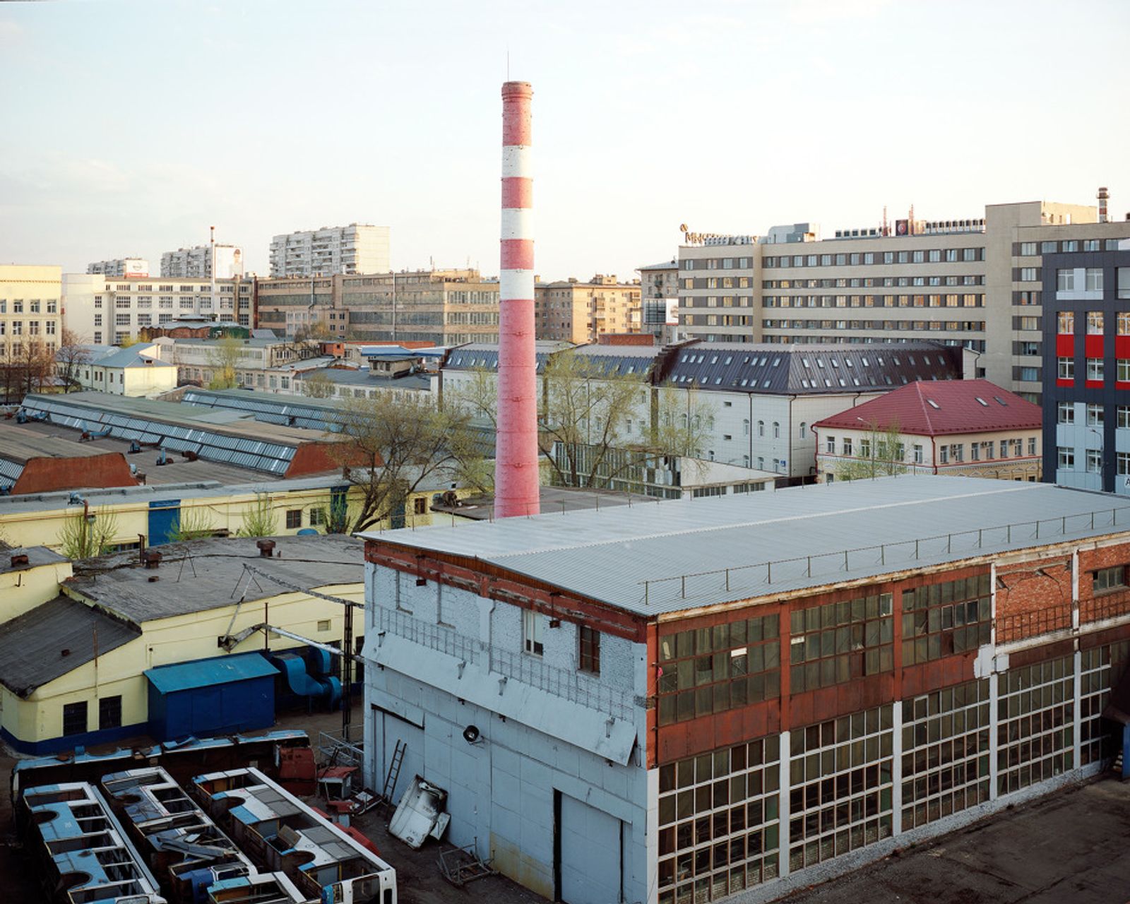 © Petr Antonov - Trolleybus depot, chimney, trolleybuses, industrial compound, office buildings, trees