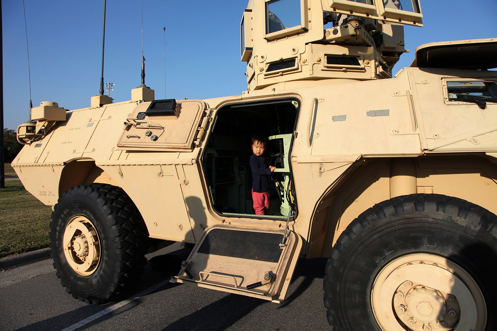 © Arin Yoon - Teo climbs in an 1117 Armored Security Vehicle during a family day visit to Fort Stewart, Georgia, in 2016.
