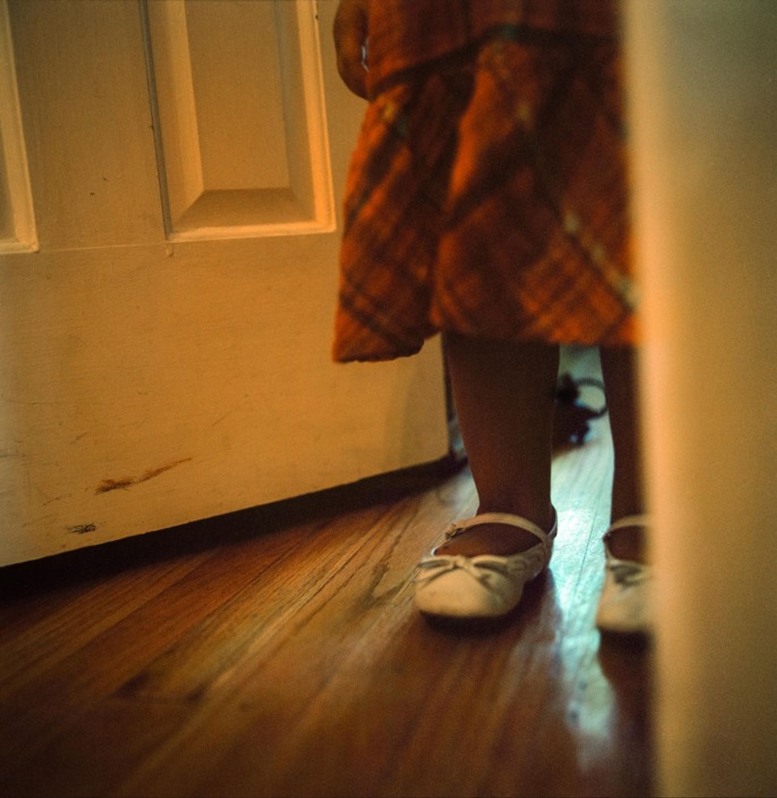 © Ruth Prieto - Lluvia stands on the door just after her mom yelled at her.