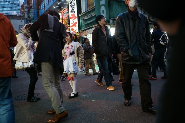 © Isabella Borrelli - A little girl attracts customers to the maid cafe where she works.