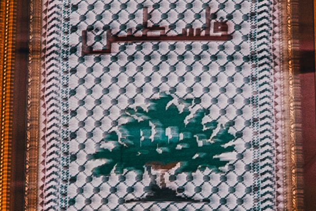 © Glorianna Ximendaz - An embroidery from a friend, with the word “Palestine” stitched into the fabric of a Keffiyeh.