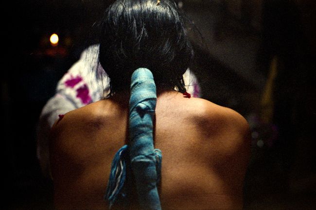 © Misha Vallejo - An indigenous woman during the cleaning ritual.